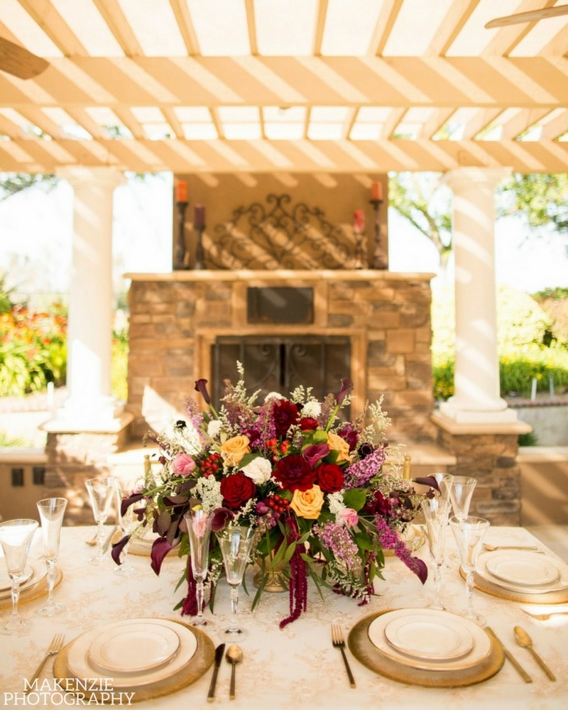 Floral reception table beneath the ranch gazebo